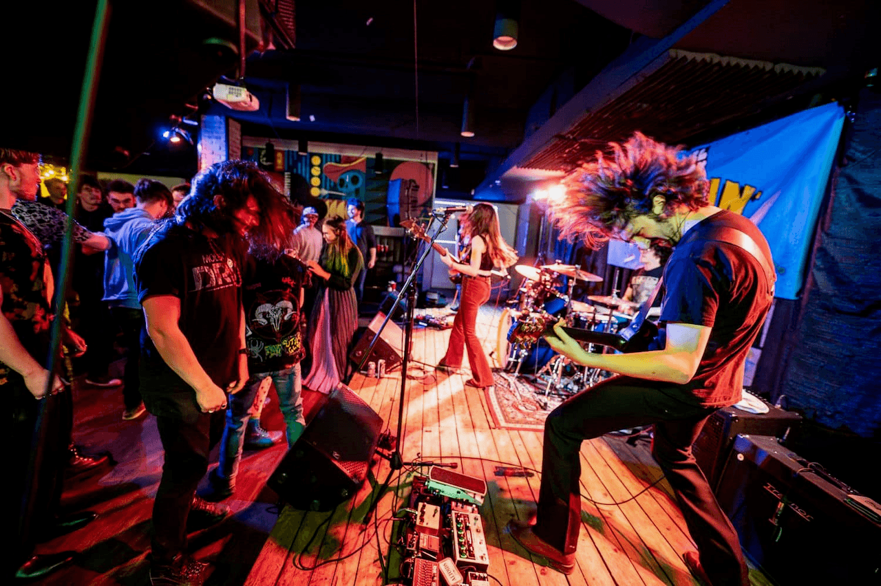 Crowd tunnel moment at a live show with high audience energy.