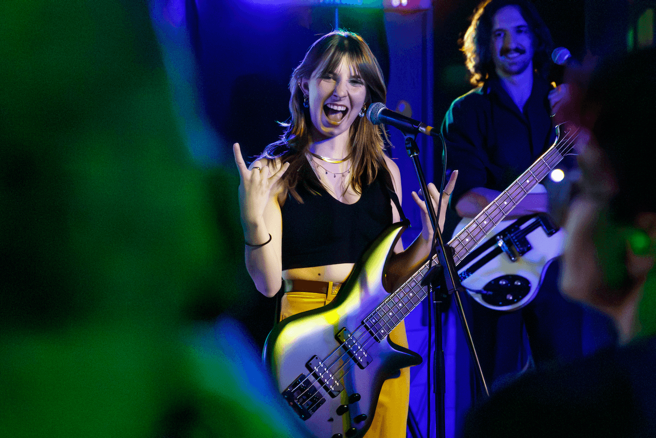 Tori Morley performing live with bass and vocals.