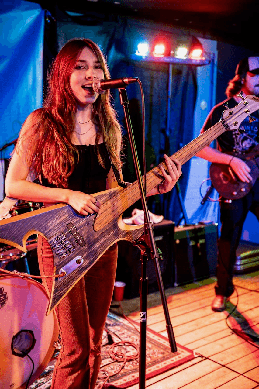 Tori Morley with custom bass on stage.